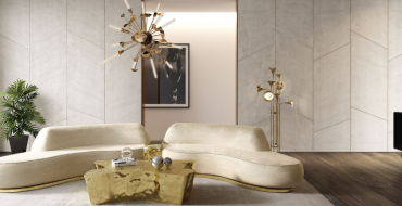A living room with a netral tones with a gold modern coffee table, a nude, cream sofa and a chandelier gold.