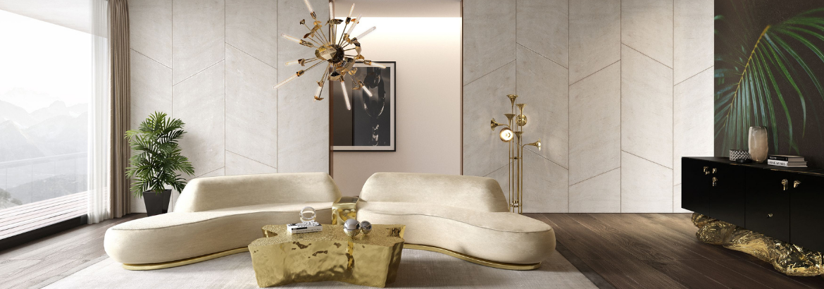 A living room with a netral tones with a gold modern coffee table, a nude, cream sofa and a chandelier gold.