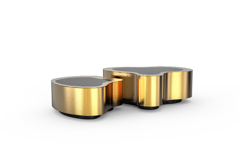 a modern coffee table with a wave shape design in a hammered brass and black mirror in the top